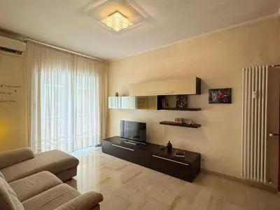 a living room with a couch and a television at Hidden Gem in Magliana in Rome