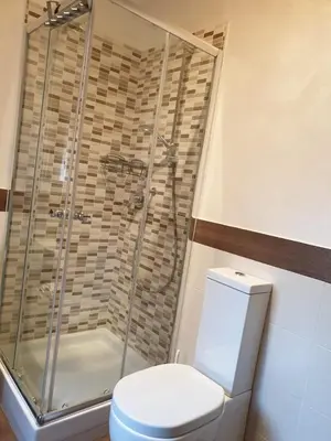 a bathroom with a toilet and a glass shower at Roma Trastevere Holiday in Rome