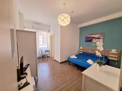 a bedroom with a blue bed in a room at Roma Trastevere Holiday in Rome