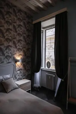 a bedroom with a bed and a window at loft a Castel S Angelo A e B in Rome