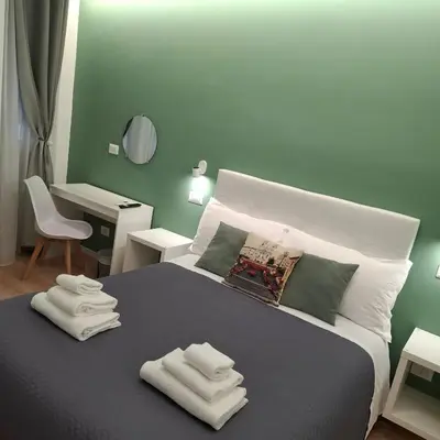 a bedroom with a bed with towels on it at Bemy in Rome
