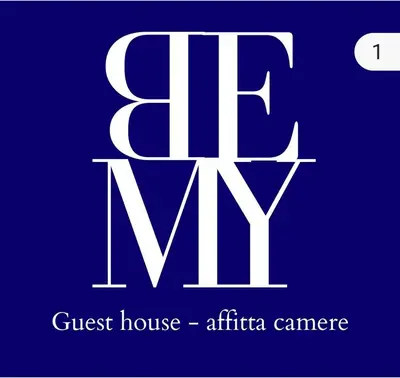 a white sign with the text guest house africa camera at Bemy in Rome