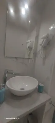 a white sink in a bathroom with a mirror at Bemy in Rome