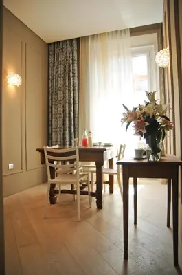 a dining room with a table and chairs and a window at B&B Carini 58 in Rome