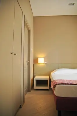 a bedroom with a bed and a table with a lamp at B&B Carini 58 in Rome