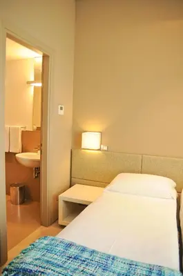 a hotel room with a bed and a sink at B&B Carini 58 in Rome