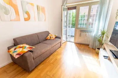 a living room with a couch and a wooden floor at 