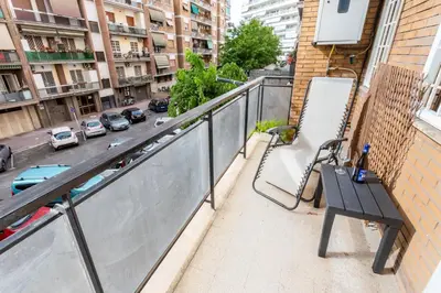 a balcony with a bench and a view of a city at 