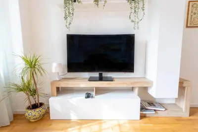 a flat screen tv sitting on top of a wooden table at 