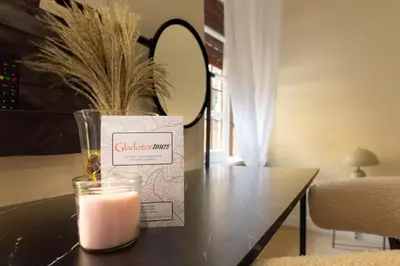 a candle sitting on a table next to a box at Aureum Angelicum in Rome