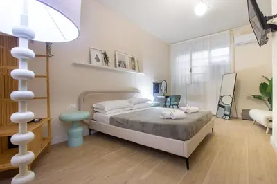 a bedroom with a bed and a lamp in it at Aureum Angelicum in Rome