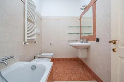 a bathroom with a sink and a toilet and a tub at Daplace - Palazzina Cosima in Rome