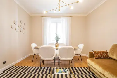 a living room with a table and chairs at Daplace - Palazzina Cosima in Rome