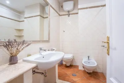 a bathroom with a sink and a toilet at Daplace - Palazzina Cosima in Rome