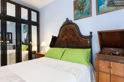 a bedroom with a bed with a green pillow on it at B&B all'ombra del Vaticano in Rome