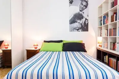 a bedroom with a bed and a book shelf at B&B all'ombra del Vaticano in Rome
