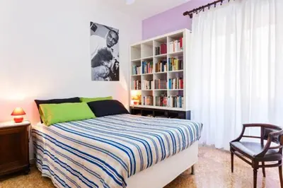 a bedroom with a bed and a book shelf at B&B all'ombra del Vaticano in Rome