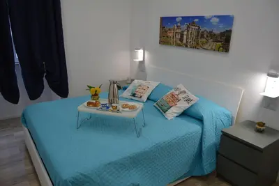 a bedroom with a bed with a tray of food on it at Casa Amabile in Rome