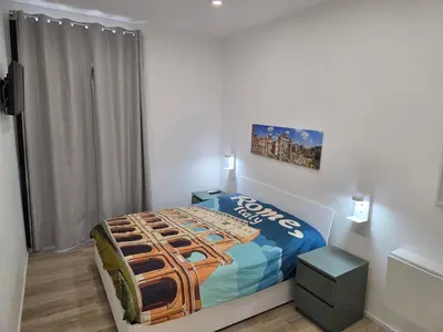 a bedroom with a bed in a white room at Casa Amabile in Rome