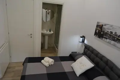 a bedroom with a black and white bed and a sink at Casa Amabile in Rome