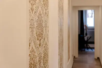 a wall with a gold embroidery on a wall at 24VaticanSuite in Rome