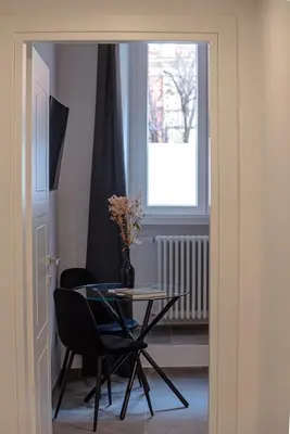 a table and chairs in a room with a window at 24VaticanSuite in Rome