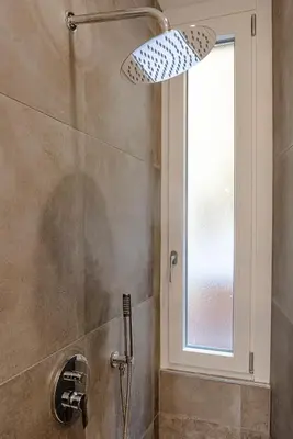 a bathroom with a shower with a window at 24VaticanSuite in Rome