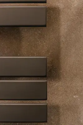 a close up of three metal steps on a wall at 24VaticanSuite in Rome