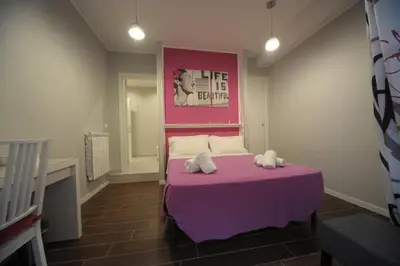 a bedroom with a purple bed with two stuffed animals on it at Bbrothershouse in Rome