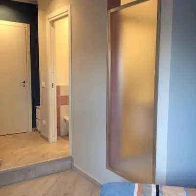 a bathroom with a sliding glass door and a mirror at Bbrothershouse in Rome