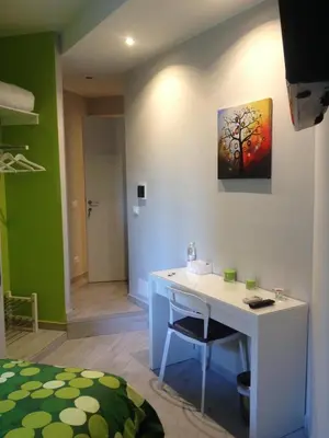 a room with a desk and a painting on the wall at Bbrothershouse in Rome
