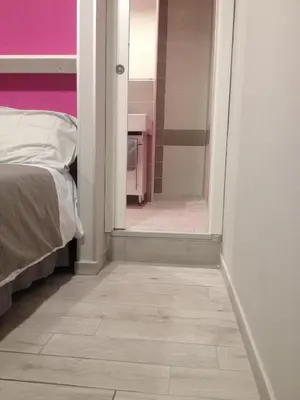 a room with a bed and a floor with a mirror at Bbrothershouse in Rome