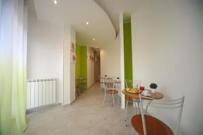 a dining room with a table and chairs and green walls at Bbrothershouse in Rome