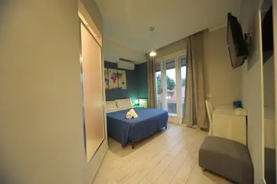 a bedroom with a blue bed and a window at Bbrothershouse in Rome