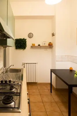 a kitchen with a stove and a counter top at Green house in Rome