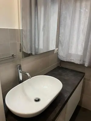 a white sink in a bathroom with a window at Appartamento Appio San Giovanni in Rome