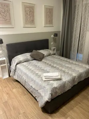 a bedroom with a bed with two towels on it at Appartamento Appio San Giovanni in Rome