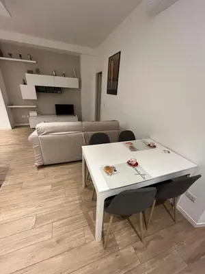 a living room with a white table and chairs at Appartamento Appio San Giovanni in Rome