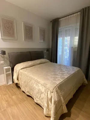 a bedroom with a bed and a window at Appartamento Appio San Giovanni in Rome