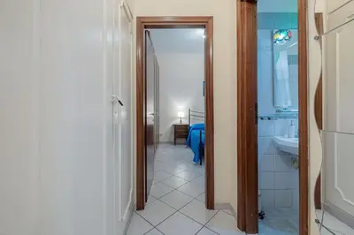 a hallway with a bathroom with a sink and a toilet at Vatican Cozy - Casetta Vaticana in Rome