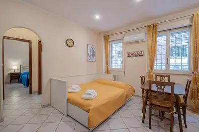 a bedroom with a bed and a table and a desk at Vatican Cozy - Casetta Vaticana in Rome