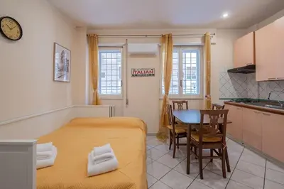 a bedroom with a bed and a table in a kitchen at Vatican Cozy - Casetta Vaticana in Rome