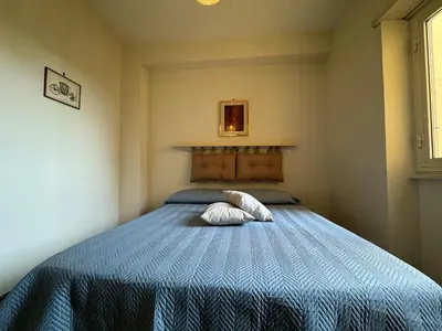 a bedroom with a bed with a blue comforter at Apt with balcony in Roman Quiet in Rome