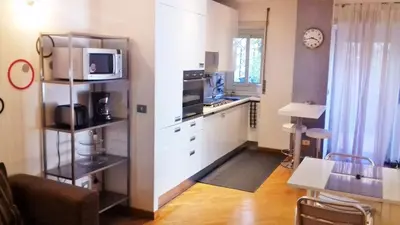 a kitchen with white cabinets and a microwave at We Love It - BestBnB Garbatella in Rome