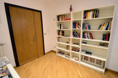 a room with white book shelves and a door at We Love It - BestBnB Garbatella in Rome