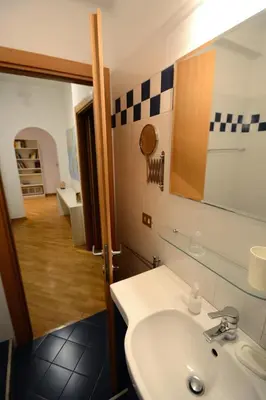 a bathroom with a sink and a mirror at We Love It - BestBnB Garbatella in Rome