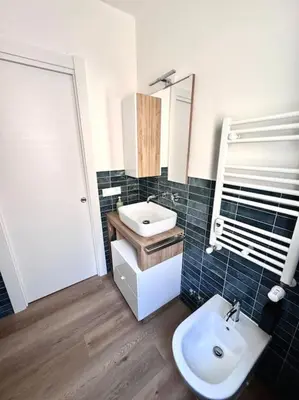 a bathroom with a sink and a toilet and a mirror at La Casa di Casa - il tuo posto speciale in Rome