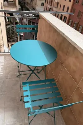 a blue table and a chair on a balcony at La Casa di Casa - il tuo posto speciale in Rome
