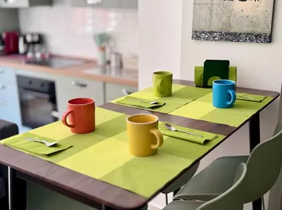 a table with four colorful mugs on top of it at La Casa di Casa - il tuo posto speciale in Rome