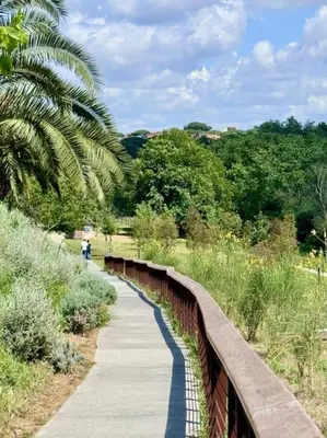 a bridge over a walkway with a road and trees at La Casa di Casa - il tuo posto speciale in Rome